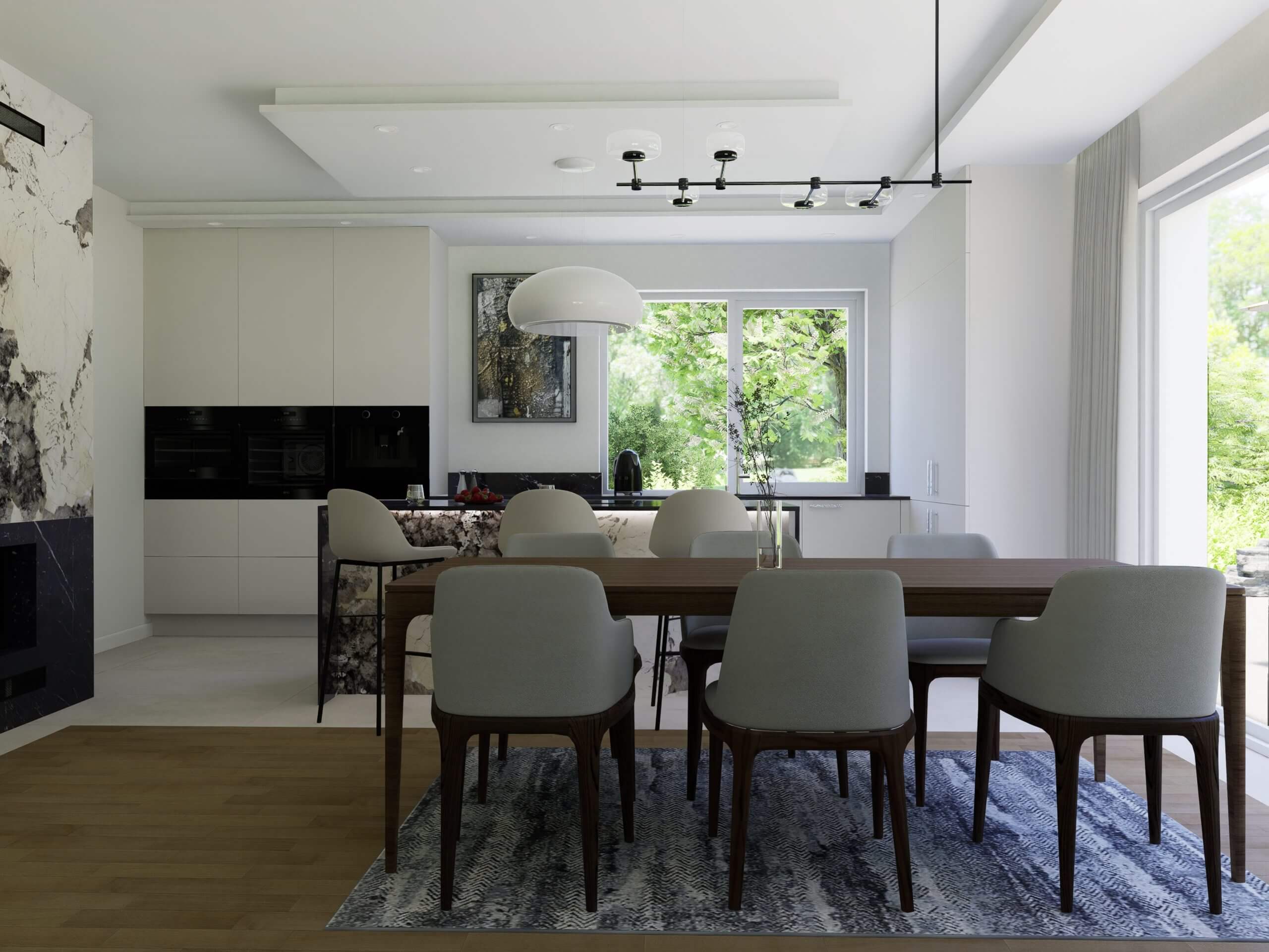 Na zdjęciu przedstawiono przestronną, dobrze oświetloną kuchnię połączoną z jadalnią. Kuchnia charakteryzuje się nowoczesnymi, białymi szafkami bez uchwytów, które zapewniają czysty i minimalistyczny wygląd. Czarny sprzęt AGD tworzy elegancki kontrast, a marmurowe akcenty na ścianie dodają luksusowego wyglądu. Jadalnia wyposażona jest w drewniany stół z zestawem szarych tapicerowanych krzeseł, które stoją na dekoracyjnym, wzorzystym dywanie. Całość tworzy harmonijną i funkcjonalną przestrzeń, idealną do wspólnego gotowania, jedzenia i spędzania czasu. Zapraszamy do poznania oferty Aksent na meble kuchenne na wymiar, które łączą w sobie funkcjonalność z nowoczesnym wzornictwem. Nasza oferta obejmuje eleganckie, białe szafki, które są nie tylko stylowe, ale także wykonane z myślą o optymalnym wykorzystaniu przestrzeni. Z Aksent masz możliwość dostosowania każdego elementu kuchni do własnych potrzeb, od wyboru materiałów po kolorystykę i rodzaj wykończenia. Nasze meble są zaprojektowane, aby komplementować każdą przestrzeń, zapewniając jednocześnie trwałość i łatwość w utrzymaniu czystości. Dzięki naszym spersonalizowanym rozwiązaniom możesz cieszyć się kuchnią, która jest tak wyjątkowa jak Ty. Skontaktuj się z nami, aby skonsultować swoje pomysły i zacząć tworzyć kuchnię marzeń już dzisiaj.